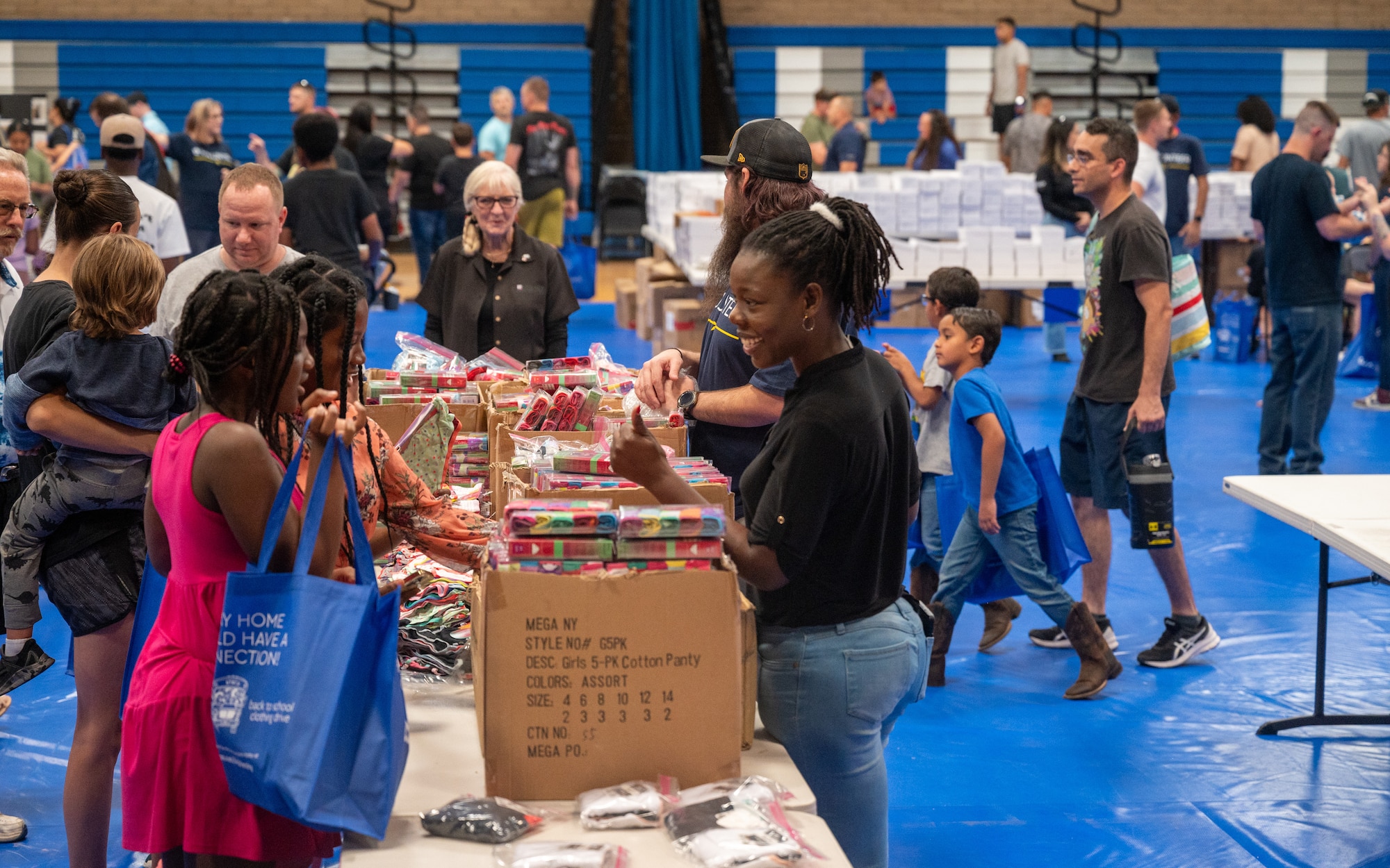 Volunteers give out school supplies during a Back-to-School Bash event June 1, 2024, at Luke Air Force Base, Arizona.