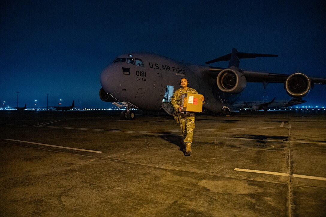 U.S. Air Force Staff Sgt. Thiago Goes, 70th Aerial Port Squadron special handler/joint inspector, carries a box of donated blood from a C-17 Globemaster III during Resolute Sentinel 2024 in Lima, Peru, May 30, 2024. The blood shipment was the first time RS24 transported blood into Peru. RS24 is a multinational training opportunity that offers real-world benefits to the participating nations of Peru, Colombia, Ecuador, Chile, Brazil, France and the United States. (U.S. Air Force photo by Senior Airman Courtney Sebastianelli)