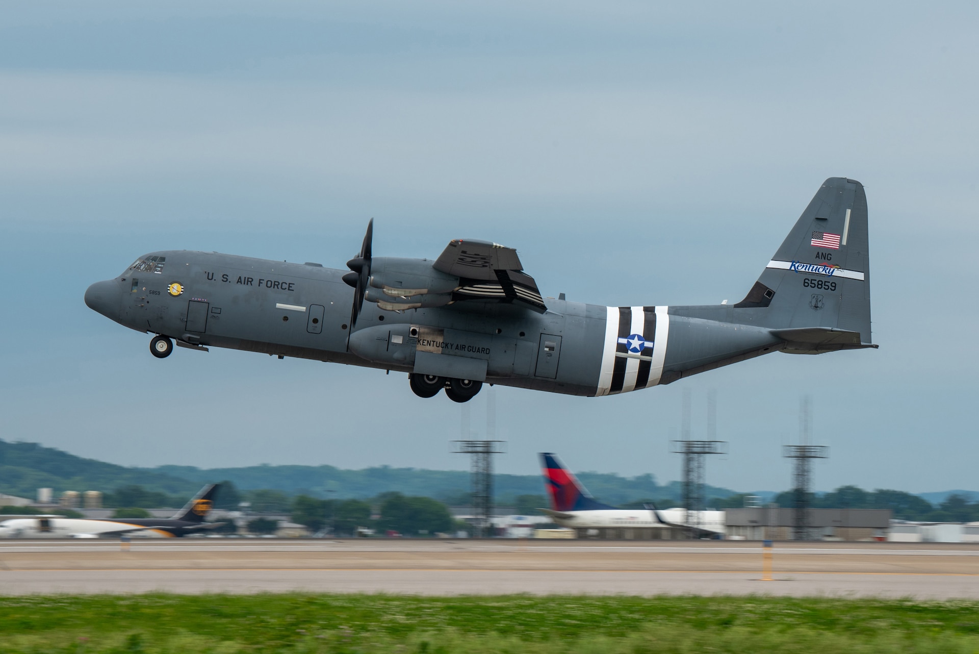 A C-130J Super Hercules assigned to the 123rd Airlift Wing takes off from the Kentucky Air National Guard Base in Louisville, Ky., May 22, 2024, bearing the distinctive livery displayed on U.S. aircraft during World War II. The plane will fly over France on June 6 as part of observances for the 80th anniversary of D-Day, when Allied forces invaded Normandy to turn the tide of the war in Europe. (U.S. Air National Guard photo by Phil Speck)