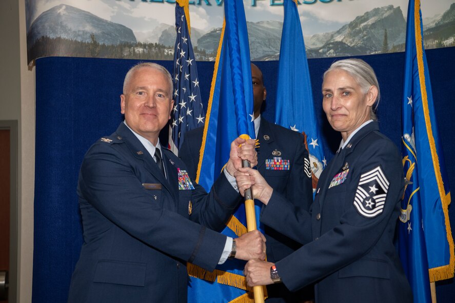 Chief Master Sgt. Vicki L. Robertson, Headquarters Air Reserve Personnel Center outgoing command chief, relinquishes command chief responsibilities from Col. Jason Knight, HQ ARPC deputy commander, during a Change of Responsibility ceremony on Buckley Space Force Base, Colorado, May. 30, 2024.