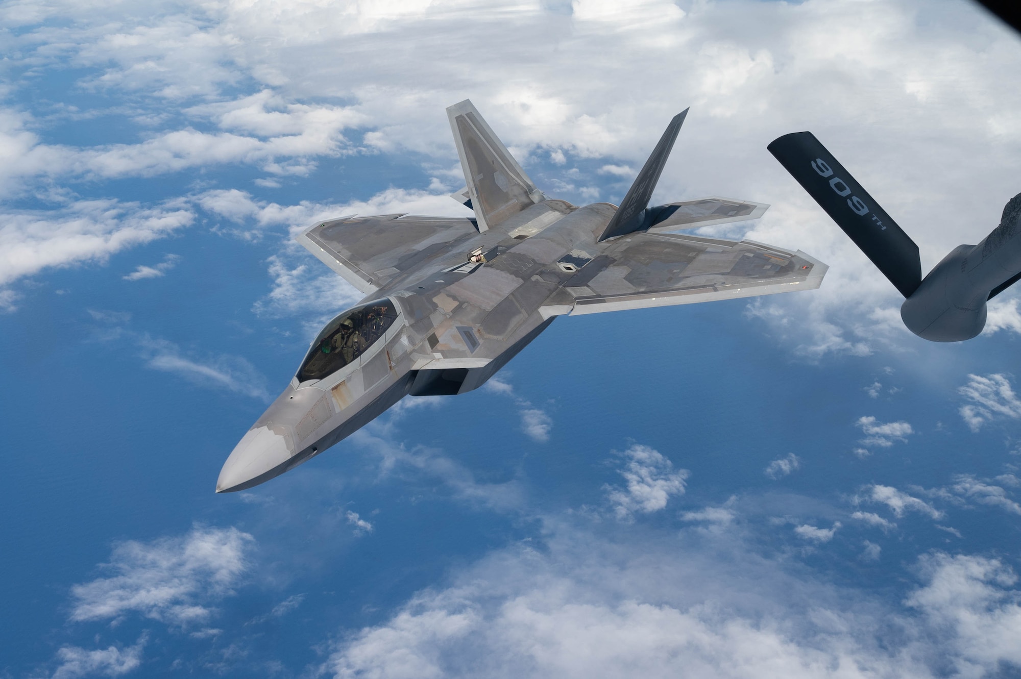 A U.S. Air Force F-22A Raptor operated by the 199th and 19th Fighter Squadrons separates from a KC-135 Stratotanker after conducting aerial refueling