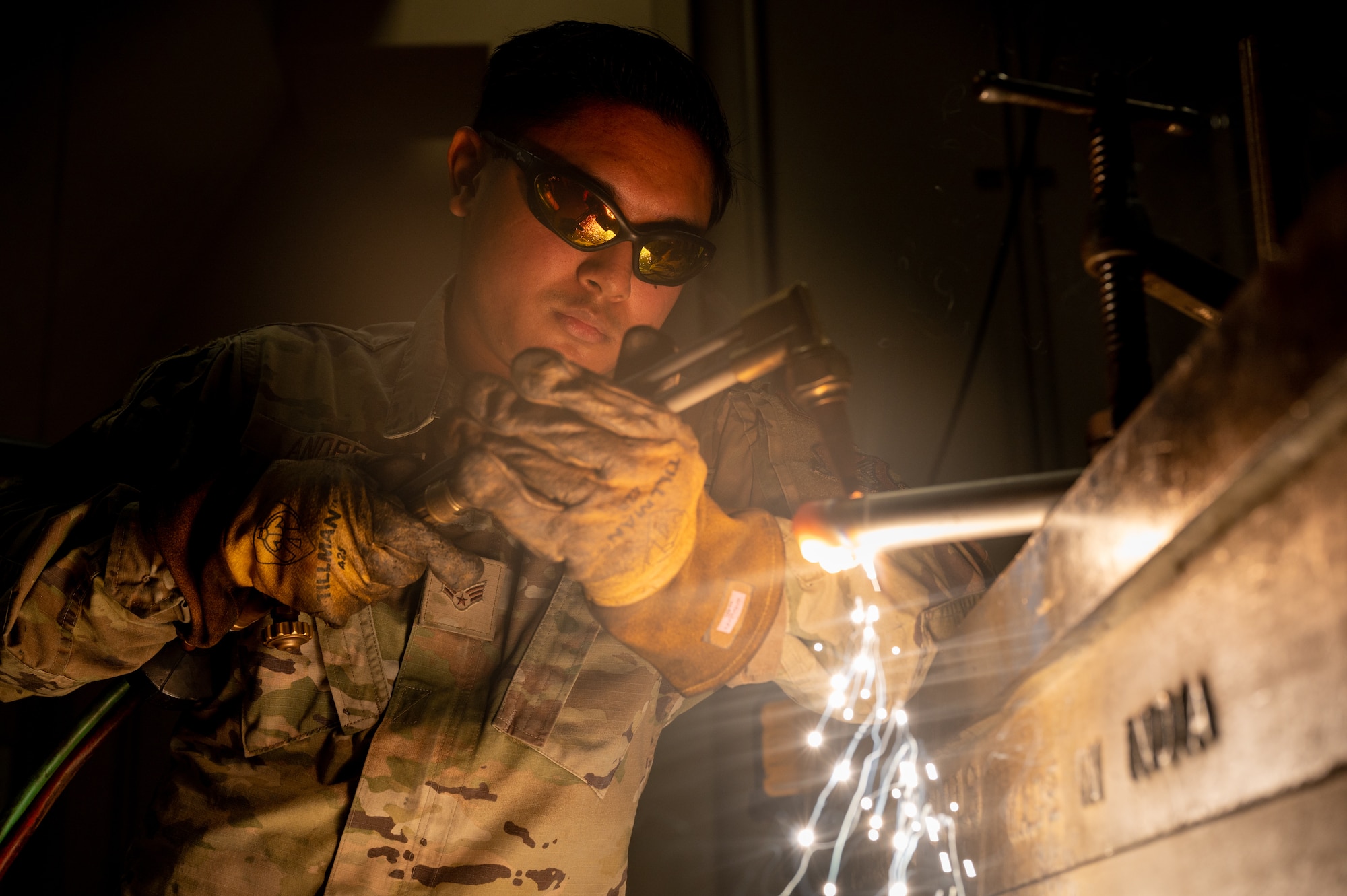 U.S. Air Force Senior Airman William Andres, 35th Maintenance Squadron (MXS) metals technology journeyman, cuts a metal bar with a welding machine at Misawa Air Base, Japan, May 28, 2024.