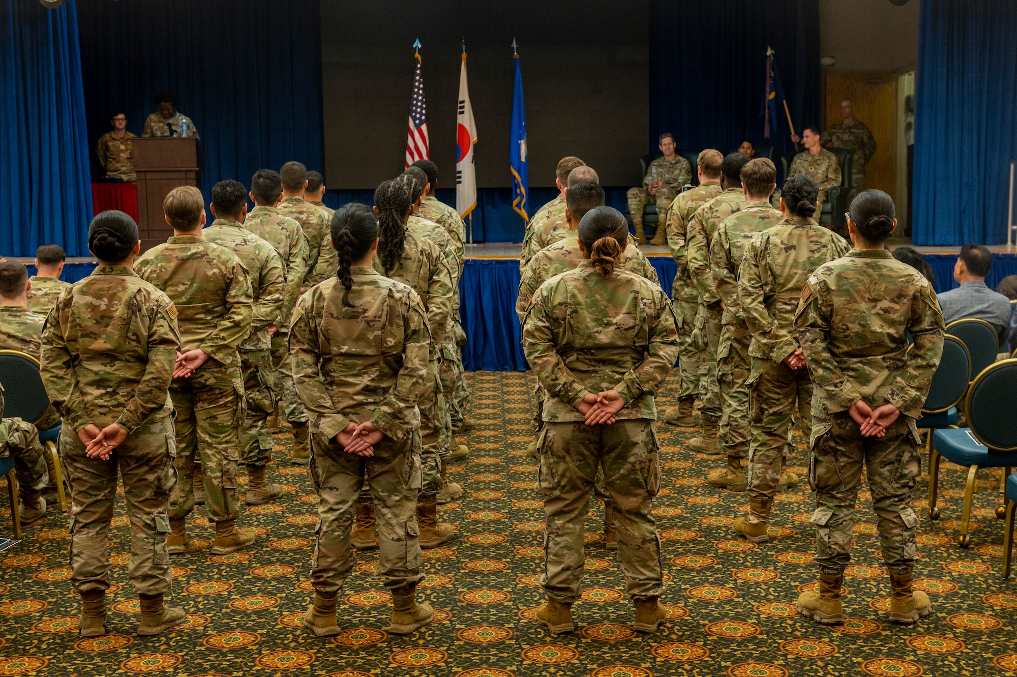 U.S. Air Force Airmen stand in formation during the 51st Comptroller Squadron Change of Command Ceremony at Osan Air Base, Republic of Korea, June 4, 2024. The change of command ceremony symbolizes the transfer of command responsibility and accountability from one individual to another. This is physically represented by the passing of the guidon, the tangible symbol of the unit, from the outgoing to incoming commander in the presence of unit personnel. (U.S. Air Force photo by Senior Airman Kaitlin Frazier)