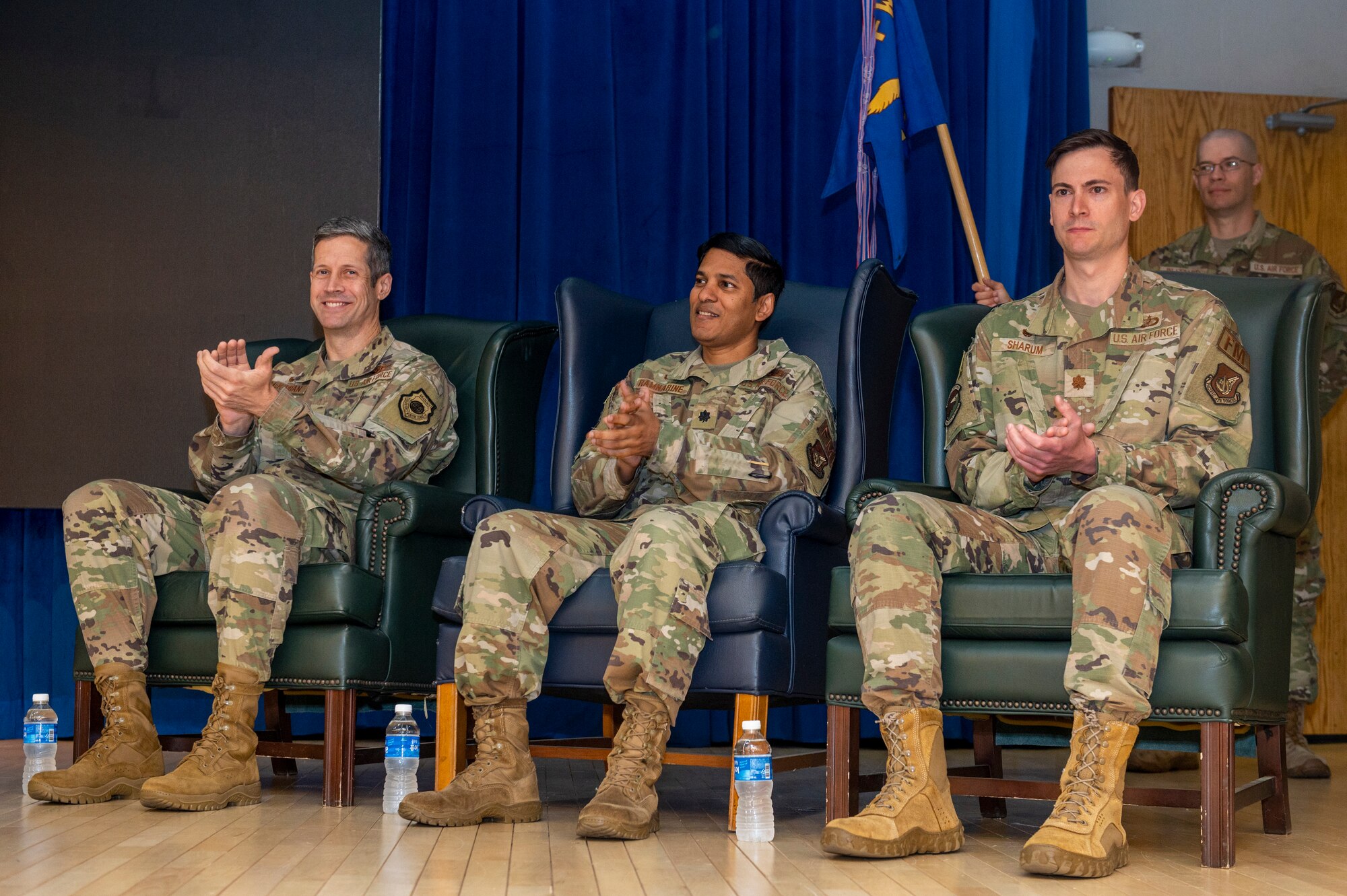 U.S. Air Force Col. William McKibban, left, 51st Fighter Wing commander, Lt. Col. Brett Ramnarine, middle, and Maj. Clayton Sharum, right, clap during opening remarks at the 51st CPTS Change of Command Ceremony at Osan Air Base, Republic of Korea, June 4, 2024. Sharum took command of the 51st CPTS as Ramnarine's assignment at Osan ended. The 51st CPTS oversees the transactions and resource management for more than 20 base organizations, keeping the base financially ready to deter any potential threats and continue mission operations. (U.S. Air Force photo by Senior Airman Kaitlin Frazier)