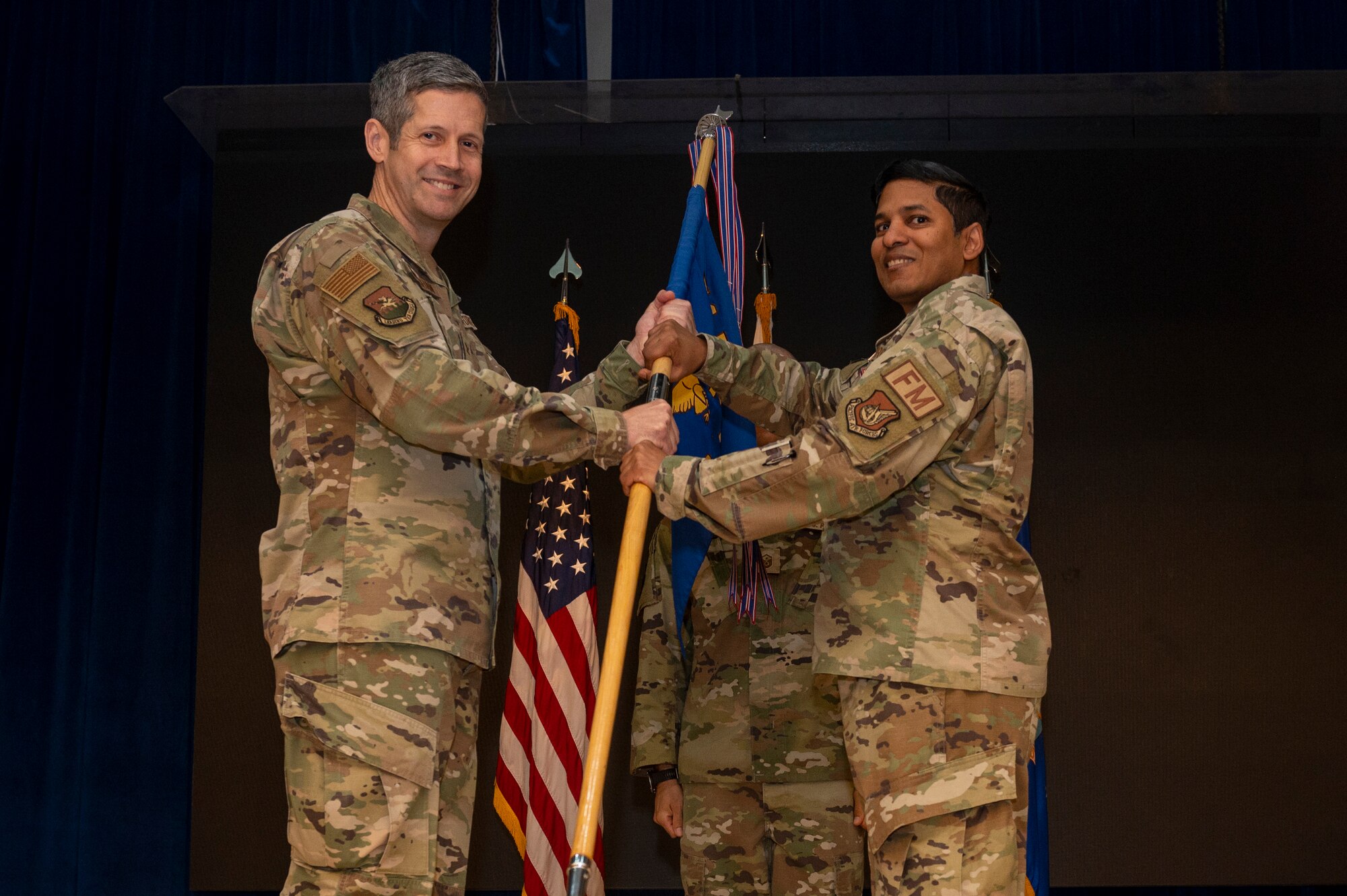 U.S. Air Force Lt. Col. Ramnarine, right, relinquishes command of the 51st Comptroller Squadron to Col. William McKibban, 51st Fighter Wing commander, left, during the 51st CPTS Change of Command ceremony at Osan Air Base, Republic of Korea, June 4, 2024. After relinquishing command, Ramnarine will move to Macdill Air Force Base, Florida, to serve as the commander for the 6th CPTS. (U.S. Air Force photo by Senior Airman Kaitlin Frazier)
