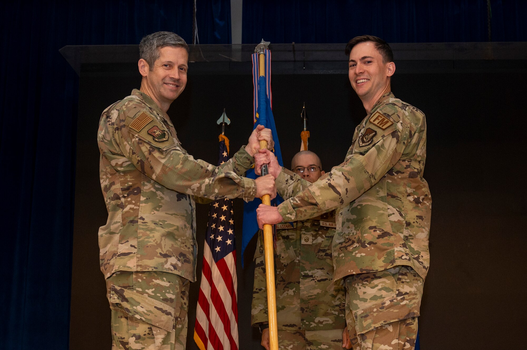 U.S. Air Force  Maj. Clayton Sharum, right, accepts command of the 51st Comptroller Squadron from Col. William McKibban, 51st Fighter Wing commander, left, during the 51st CPTS Change of Command Ceremony at Osan Air Base, Republic of Korea, June 4, 2024. Prior to taking command, Sharum served as a special action officer at Ramstein Air Base, Germany. (U.S. Air Force photo by Senior Airman Kaitlin Frazier)