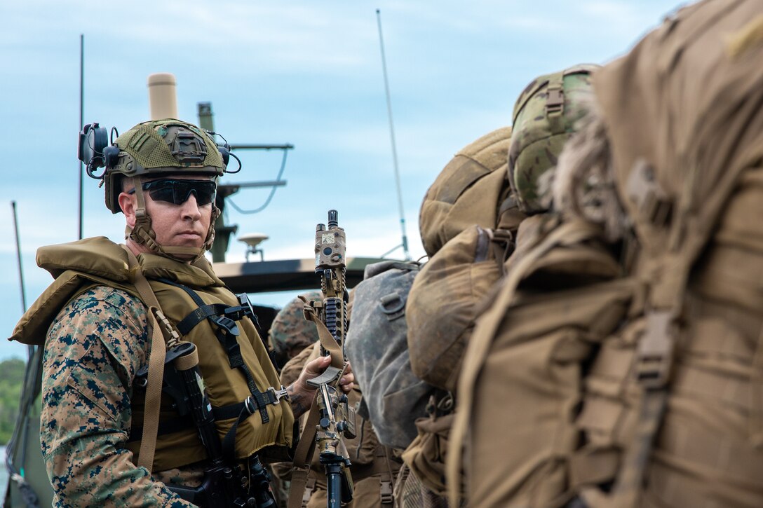U.S. Marine Corps Master Sgt. Joshua E. Owen, the battalion operations chief with Combat Logistics Battalion 8 (CLB-8), Combat Logistics Regiments 2, 2nd Marine Logistics Group, left, participates in littoral boat operations at Marine Corps Base Camp Lejeune, North Carolina, June 3, 2024. CLB-8 provided transportation support for the scout sniper platoon in order to showcase littoral combat service support. (U.S. Marine Corps photo by Lance Cpl. Jack Labrador)