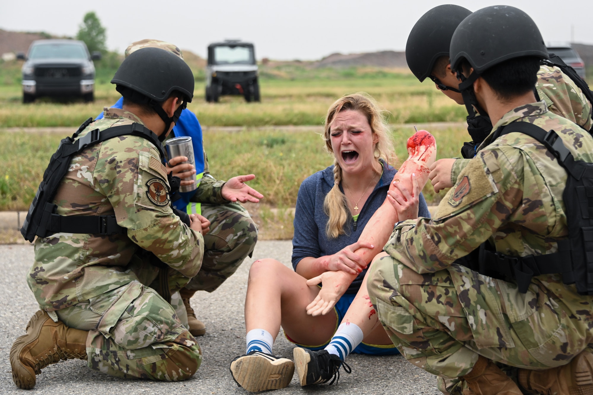 U.S. Air Force Capt. Mary M. Nelson, 97th Healthcare Operations Squadron pediatrician, assumes the role of a patient having a panic attack at Altus Air Force Base, Oklahoma, May 23, 2024. Nelson imitated a person in mental distress to educate the service members on how to treat a patient with this condition. (U.S. Air Force photo by Airman Lauren Torres)