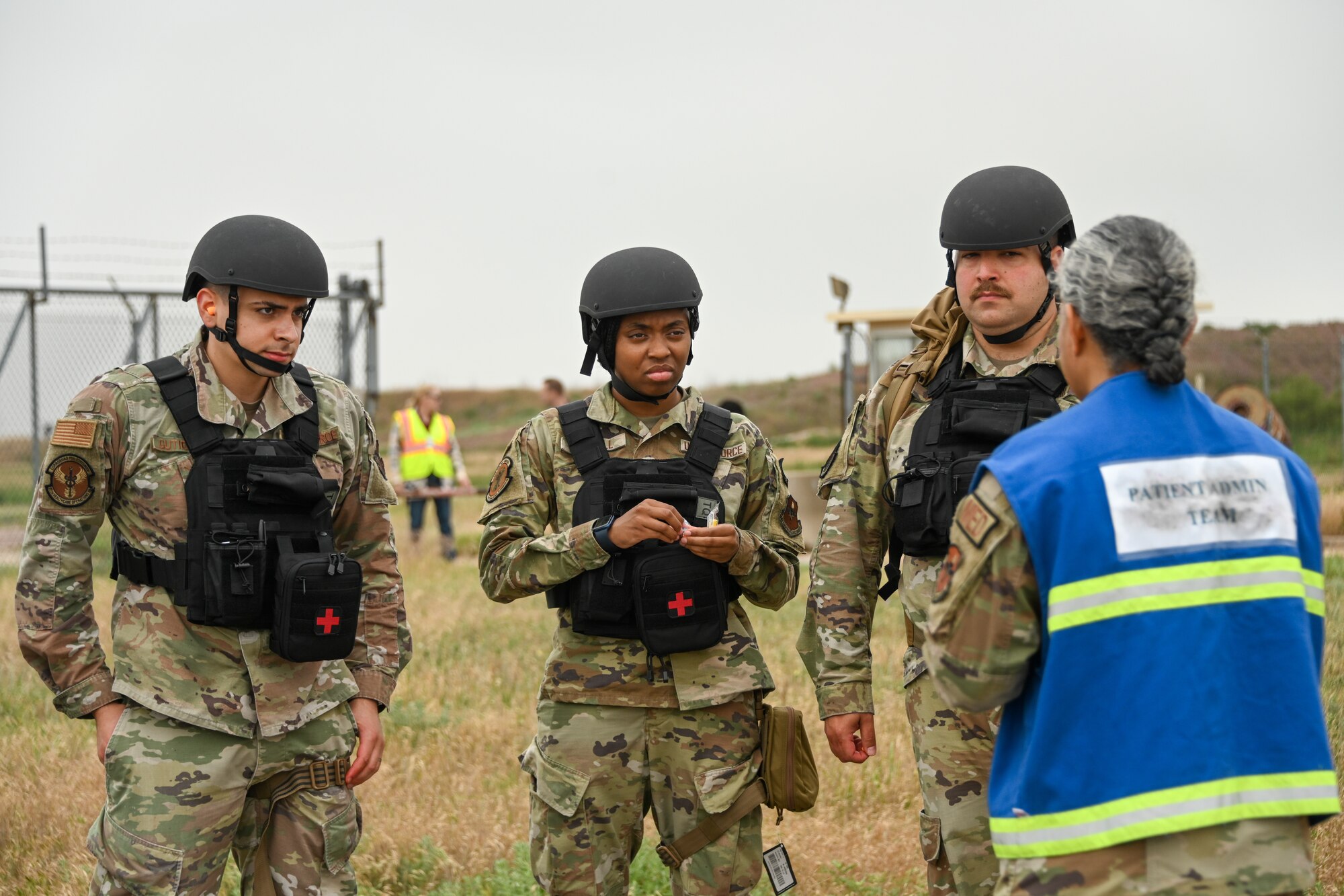 Airmen from the 97th Medical Group (MDG) and the 71st MDG listen to Lt. Col. Shanti Jones, 97th Operational Medical Readiness Squadron commander, during Caduceus Spear at Altus Air Force Base, Oklahoma, May 23, 2024. Jones guided service members throughout crisis response procedures. (U.S. Air Force photo by Airman Lauren Torres)