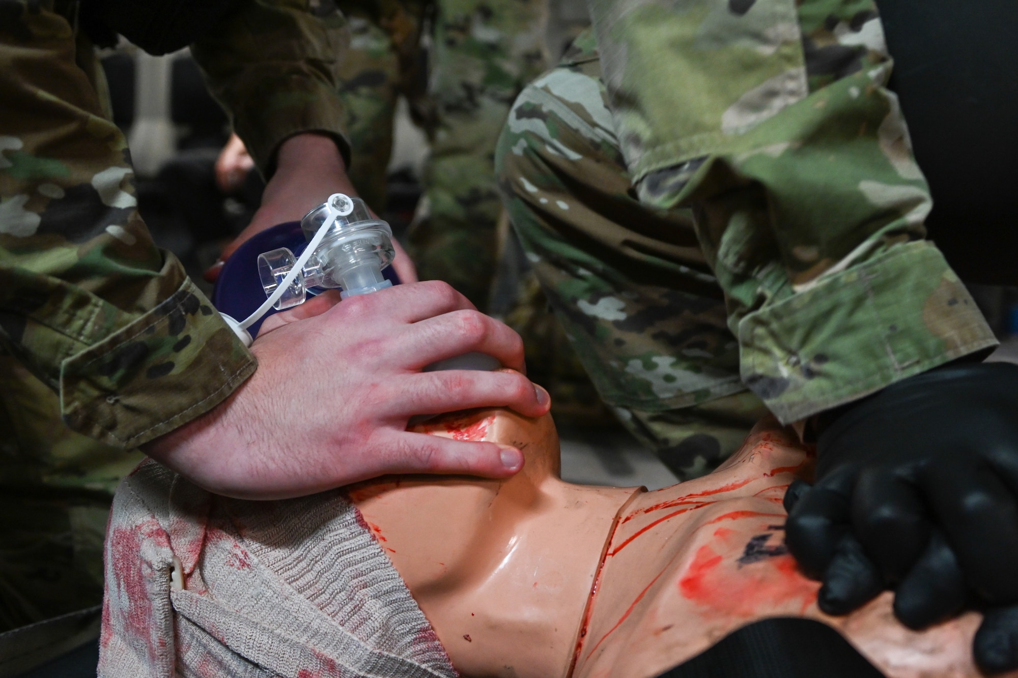Airmen perform cardiopulmonary resuscitation on a mannequin at Altus Air Force Base, Oklahoma, May 23, 2024. Service members loaded the mannequins and other injured patients onto a C-17 Globemaster III aircraft to continue training. (U.S. Air Force photo by Airman Lauren Torres)