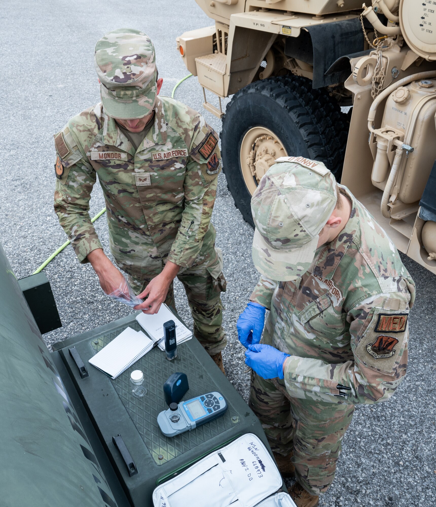 bioenvironmental engineering technicians check chlorine levels of a potable water buffalo