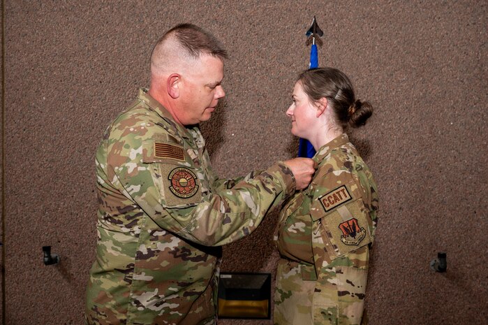 U.S. Air Force Col. Matthew Pfeiffer, left, the 99th Medical Group commander, pins the Distinguished Flying Cross medal on Maj. Shannon Diffley, the 99th Inpatient Operations Squadron critical care unit flight commander, during a ceremony at Nellis Air Force Base, Nevada, June 3, 2024.