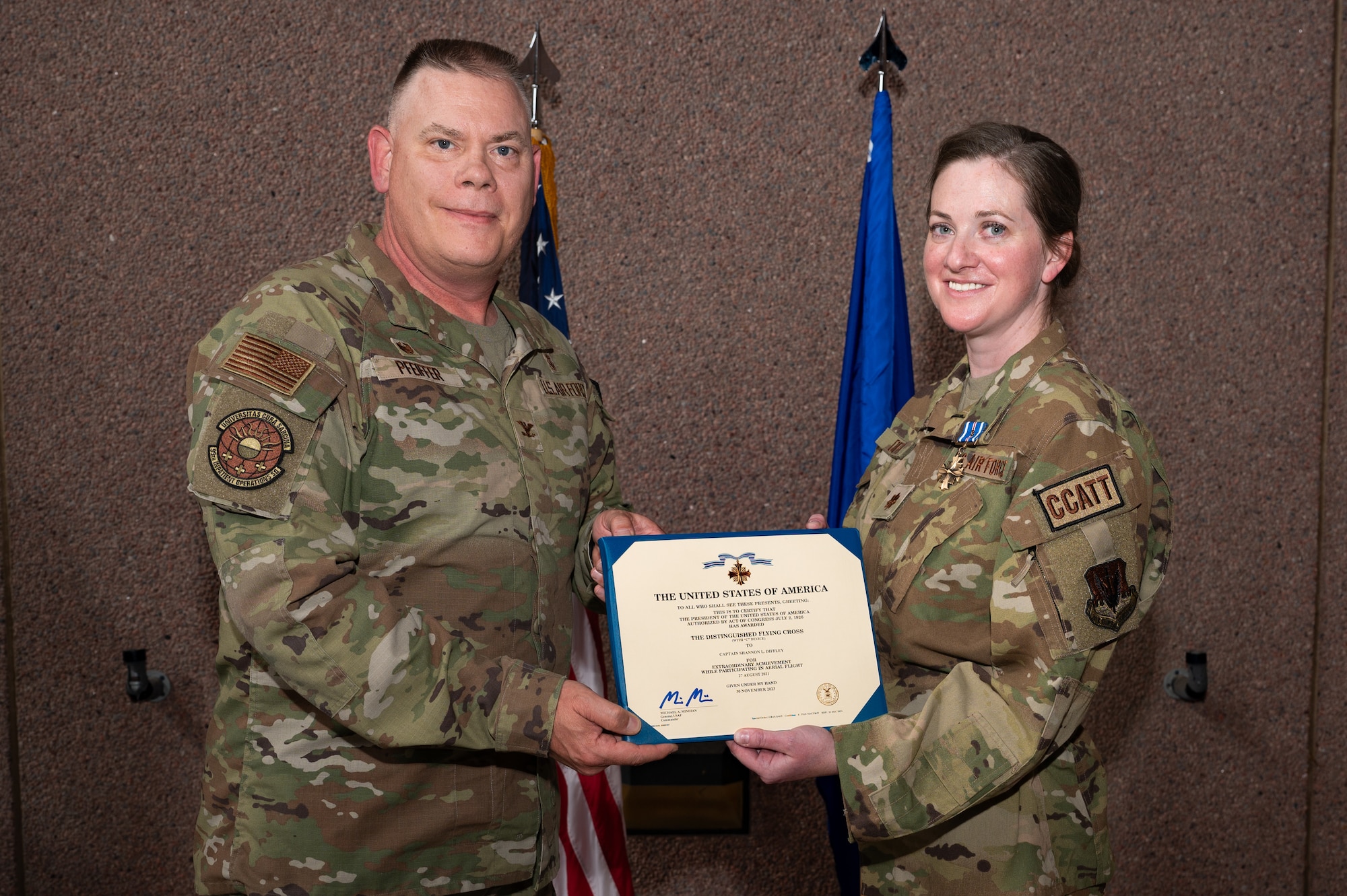 U.S. Air Force Col. Matthew Pfeiffer, left, the 99th Medical Group commander, and Maj. Shannon Diffley, the 99th Inpatient Operations Squadron critical care unit flight commander, pose for a photo during a ceremony at Nellis Air Force Base, Nevada, June 3, 2024.