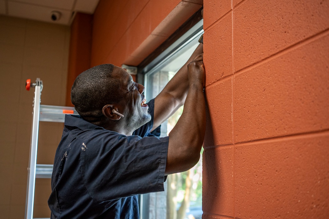 A U.S. Air Force Airman assigned to the 23rd Wing prepares a window for paint at Boys and Girls Club in Valdosta, Georgia, May 31, 2024. Volunteers from Moody Air Force Base joined forces to participate in the Valdosta City Renewal Project to improve the local community by providing essential home repairs for those in need. (U.S. Air Force photo by Airman 1st Class Leonid Soubbotine)