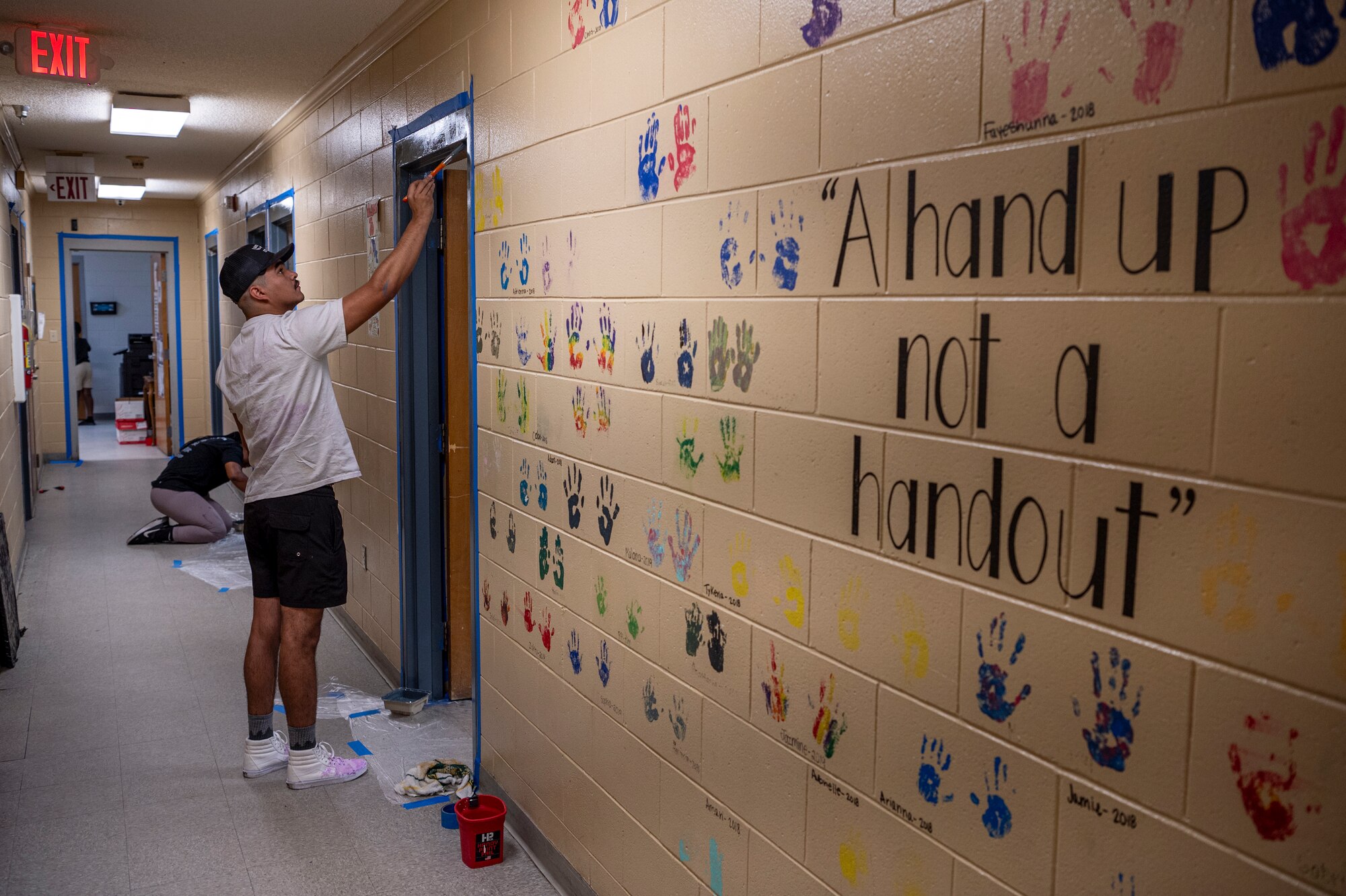U.S. Air Force Airmen assigned to the 23rd Wing paint door jambs at Lowndes Associated Ministries to People (LAMP) in Valdosta, Georgia, May 31, 2024. LAMP is a homeless shelter serving eight local counties, housing hundreds of people in need across South Georgia. (U.S. Air Force photo by Airman 1st Class Leonid Soubbotine)