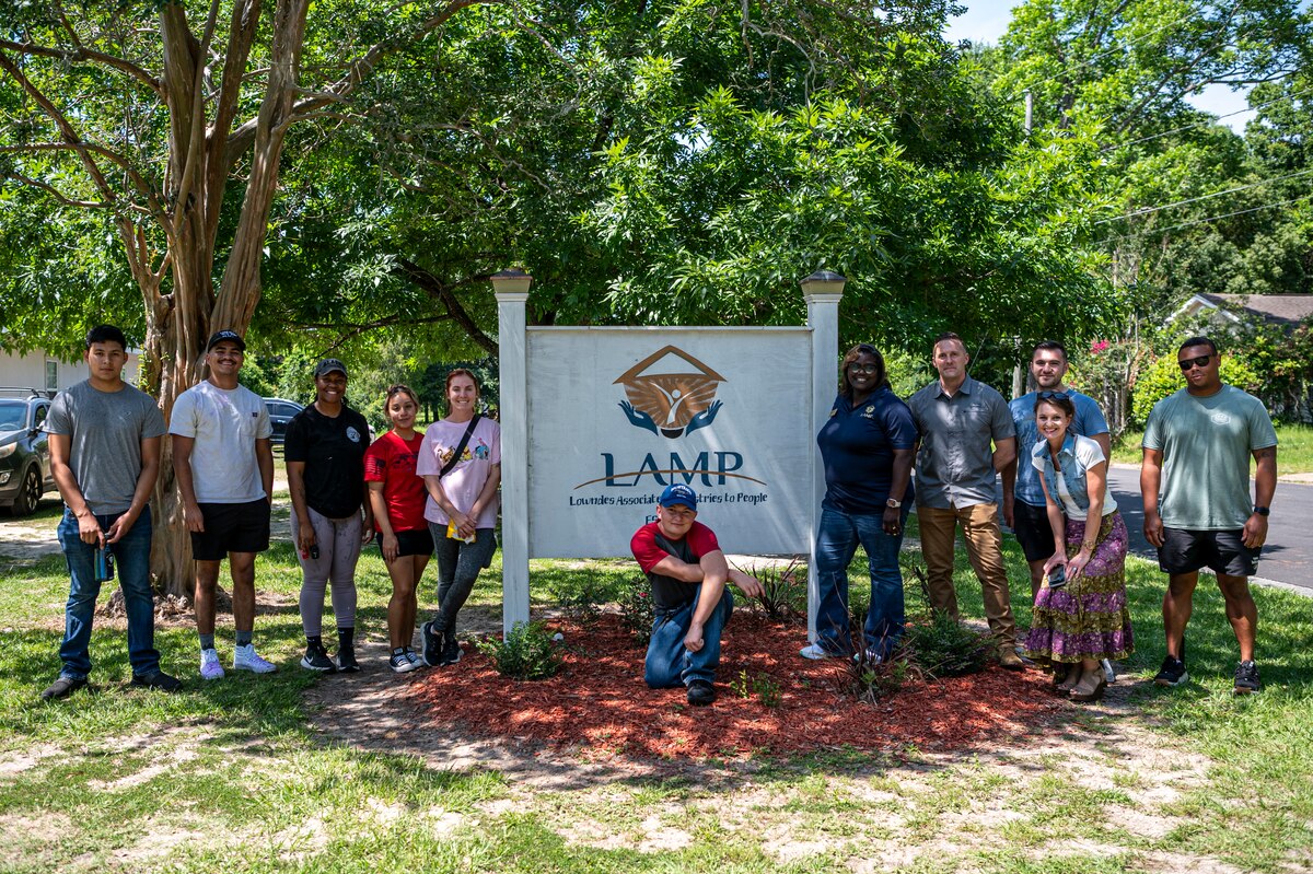 U.S. Air Force Airmen assigned to the 23rd Wing and Lowndes Associated Ministries to People (LAMP) staff pose for a photo in Valdosta, Georgia, May 31, 2024. Moody Air Force Base Airmen volunteered and participated in several projects to help the local community. (U.S. Air Force photo by Airman 1st Class Leonid Soubbotine)