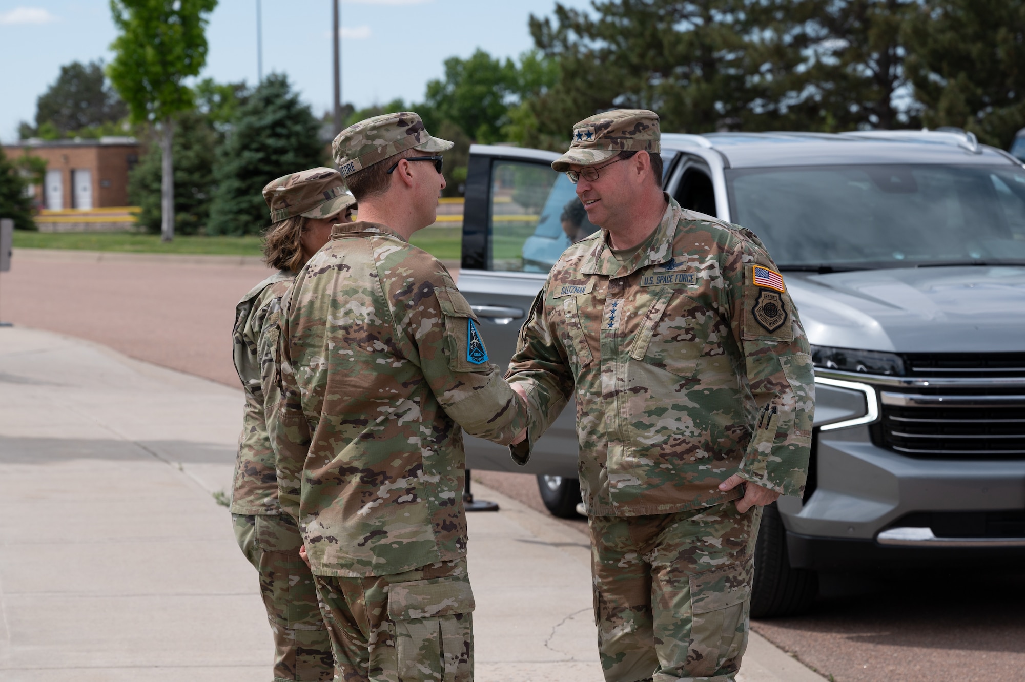 U.S. Space Force Chief of Space Operations Gen. Chance Saltzman greets Brig. Gen. Matthew Cantore, Space Training and Readiness Command deputy commander, and U.S. Space Force Chief Master Sgt. Karmann-Monique Pogue, STARCOM senior enlisted leader, outside the Moorman Space Education and Training Center at Peterson Space Force Base, Colo., May 31, 2024. (U.S. Space Force photo by Tech. Sgt. Kirsten Brandes)