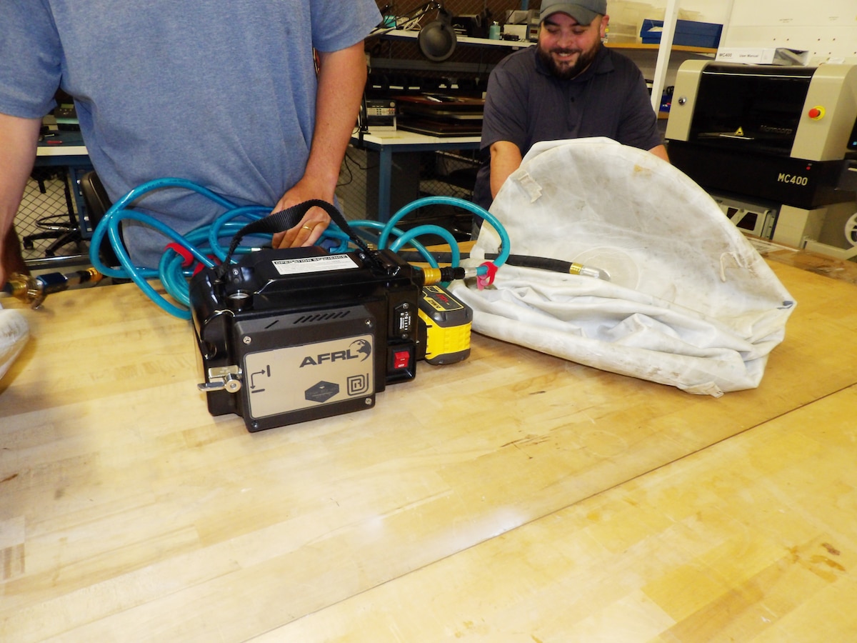 University of Dayton Research Institute Mechanical Engineer Jason Adams works on the Heavy Lift Kit, or HLK, which is a solution that the Air Force Research Laboratory Center for Rapid Innovation devised to allow the bags to be quickly deflated in contested environments at the Wright Brothers Institute Proving Ground Facility on May 21, 2024. Rescue workers can use the pairs of HLK inflatable bags to lift as much as 45,000 pounds. (Air Force photo / Patrick Foose)