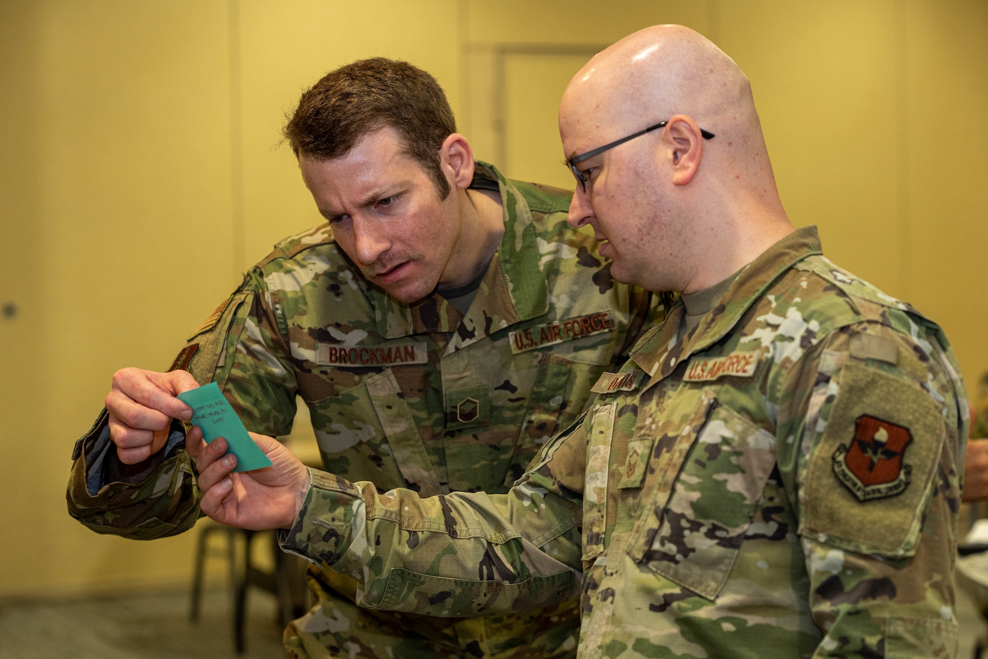 U.S. Air Force Master Sgt. Shay Brockman, 225th Air Defense Squadron flight chief, and Master Sgt. Kenneth Davis, Air Force Career Development Academy command and control battle management operations learning engineer, participate in a group activity at the occupational competency seminar on Keesler Air Force Base, Mississippi, March 19, 2024.