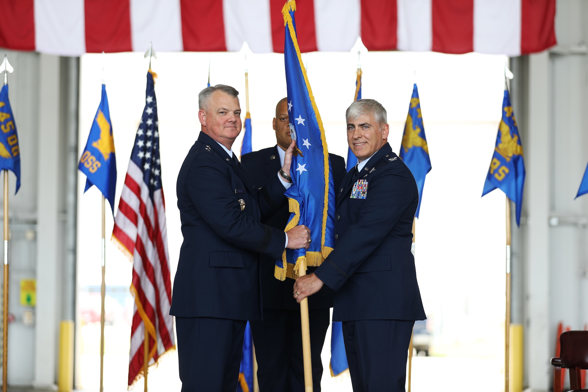 U.S. Air Force Maj. Gen. D. Scott Durham, left, 4th Air Force commander, passes the guidon to Col. Douglas Perry Jr., right, incoming 445th Airlift Wing commander, during the wing’s assumption of command ceremony at Wright-Patterson Air Force Base, Ohio, June 1, 2024. Prior to his arrival to the 445th AW, Perry served as the commander of the 434th Operations Group at Grissom Air Reserve Base, Indiana. (U.S. Air Force photo by Senior Airman Angela Jackson)