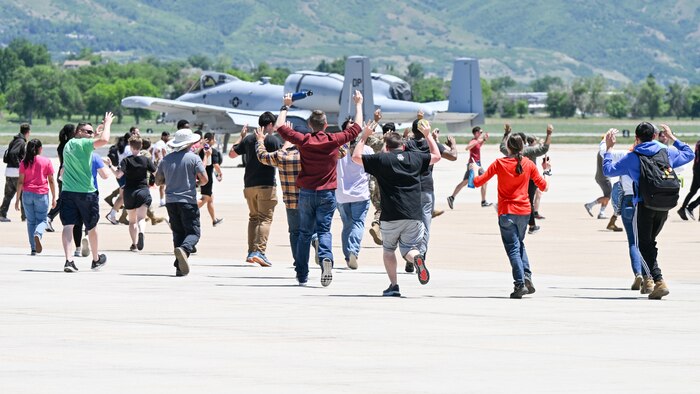 Volunteers posing as bystanders flee during a simulated active shooter training event