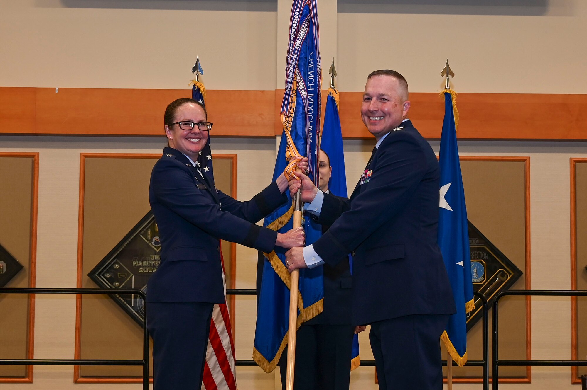Col. Daniel Voorhies accepts command from Maj. Gen. Stacy Jo Huser.