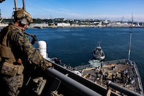 BREST, France (June 3, 2024) Lance Cpl. Warembourg, assigned to the 24th Marine Expeditionary Unit (MEU) Special Operations Capable (SOC), provides security from the bridge wing of Harper’s Ferry-class amphibious landing dock USS Oak Hill (LSD 51) while the ship’s Sailors perform sea and anchor detail on the fo’c’sle during Oak Hill’s departure from Brest, France, June 3, 2024. Oak Hill is conducting operations in U.S. Naval Forces Europe area of operations as part of the Wasp Amphibious Ready Group (WSP ARG)-24th Marine Expeditionary Unit (MEU) Special Operations Capable (SOC). The WSP ARG-24th MEU (SOC) support high-end warfighting exercises while demonstrating speed and agility operating in a dynamic security environment. (U.S. Navy photo by Mass Communication Specialist 3rd Class Justin Kemble)