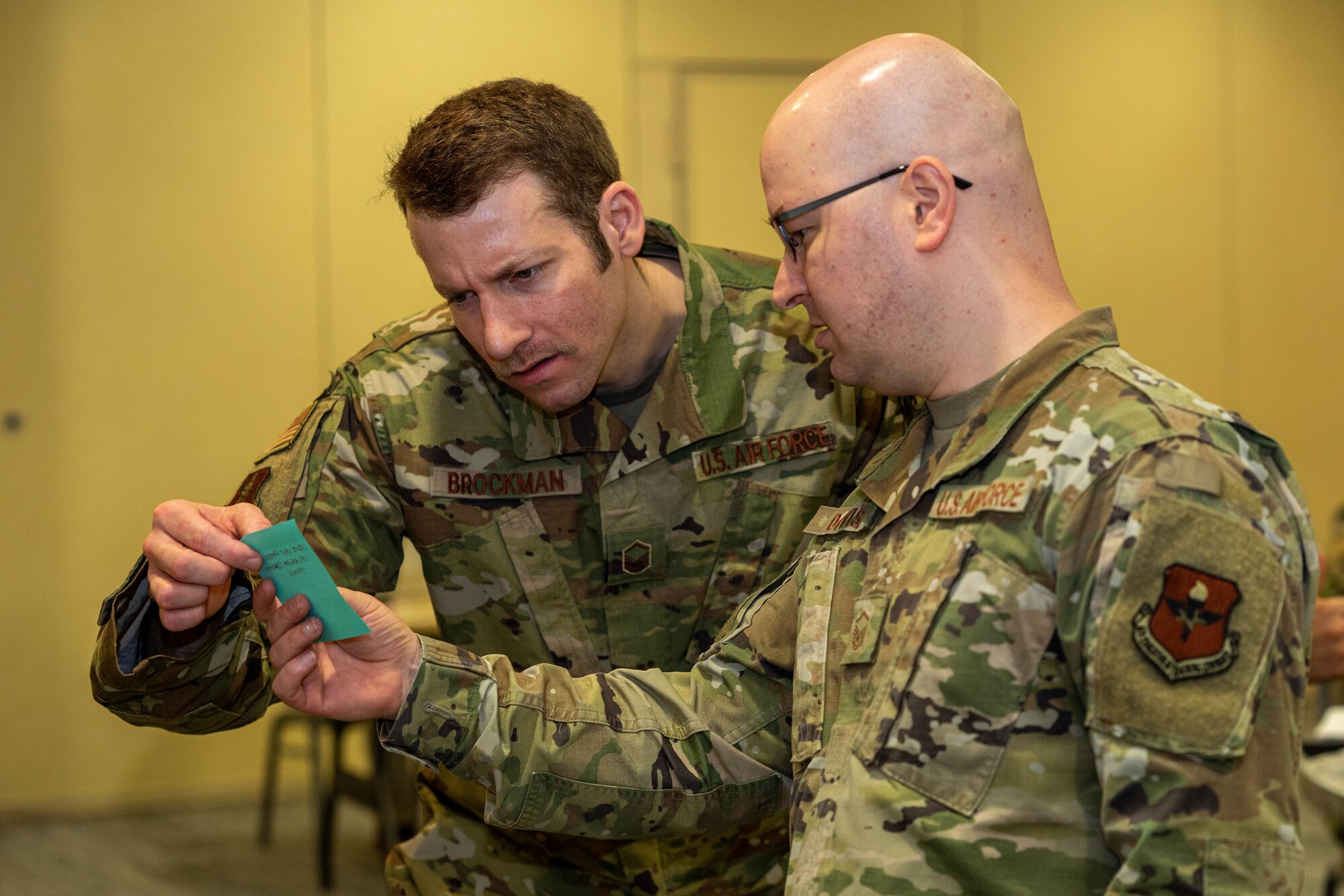 U.S. Air Force Master Sgt. Shay Brockman, 225th Air Defense Squadron flight chief, and Master Sgt. Kenneth Davis, Air Force Career Development Academy command and control battle management operations learning engineer, participate in a group activity at the occupational competency seminar on Keesler Air Force Base, Mississippi, March 19, 2024.