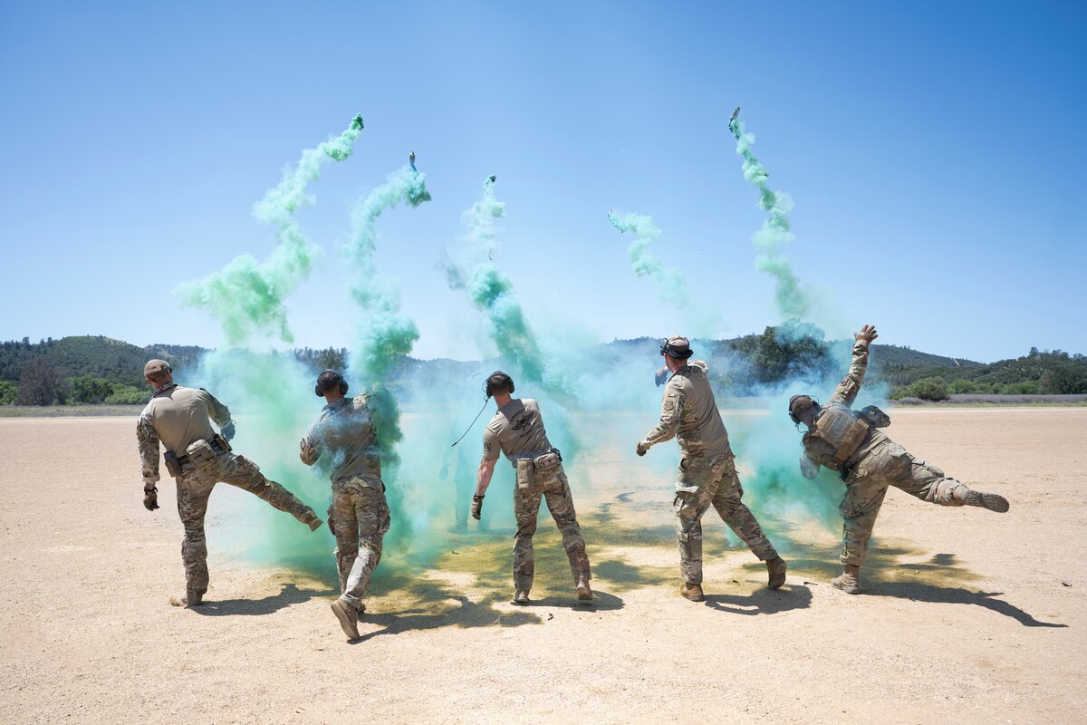 Airmen with the 821st Contingency Response Group pop smoke to assist a UH-60L Black Hawk helicopter landing during Exercise HADES SENTINEL at Fort Hunter-Liggett in Jolon, California, May 2, 2023.
