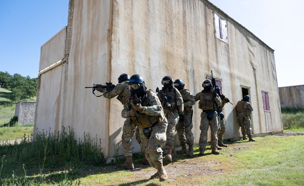 Airmen with the 821st Contingency Response Squadron prepare to clear buildings during Exercise HADES SENTINEL at Fort Hunter-Liggett in Jolon, California, May 1, 2023.