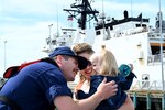A U.S. Coast Guard Cutter Munro (WMSL 755) crewmember reunites with family after the cutter returned to its home port at Base Alameda, California, on June 3, 2024, following a four-month Eastern Pacific patrol. Munro's multi-mission deployment included conducting counter-narcotics missions and Illegal, Unreported, and Unregulated (IUU) fishing patrols. U.S. Coast Guard photo by Chief Petty Officer Matthew Masaschi.