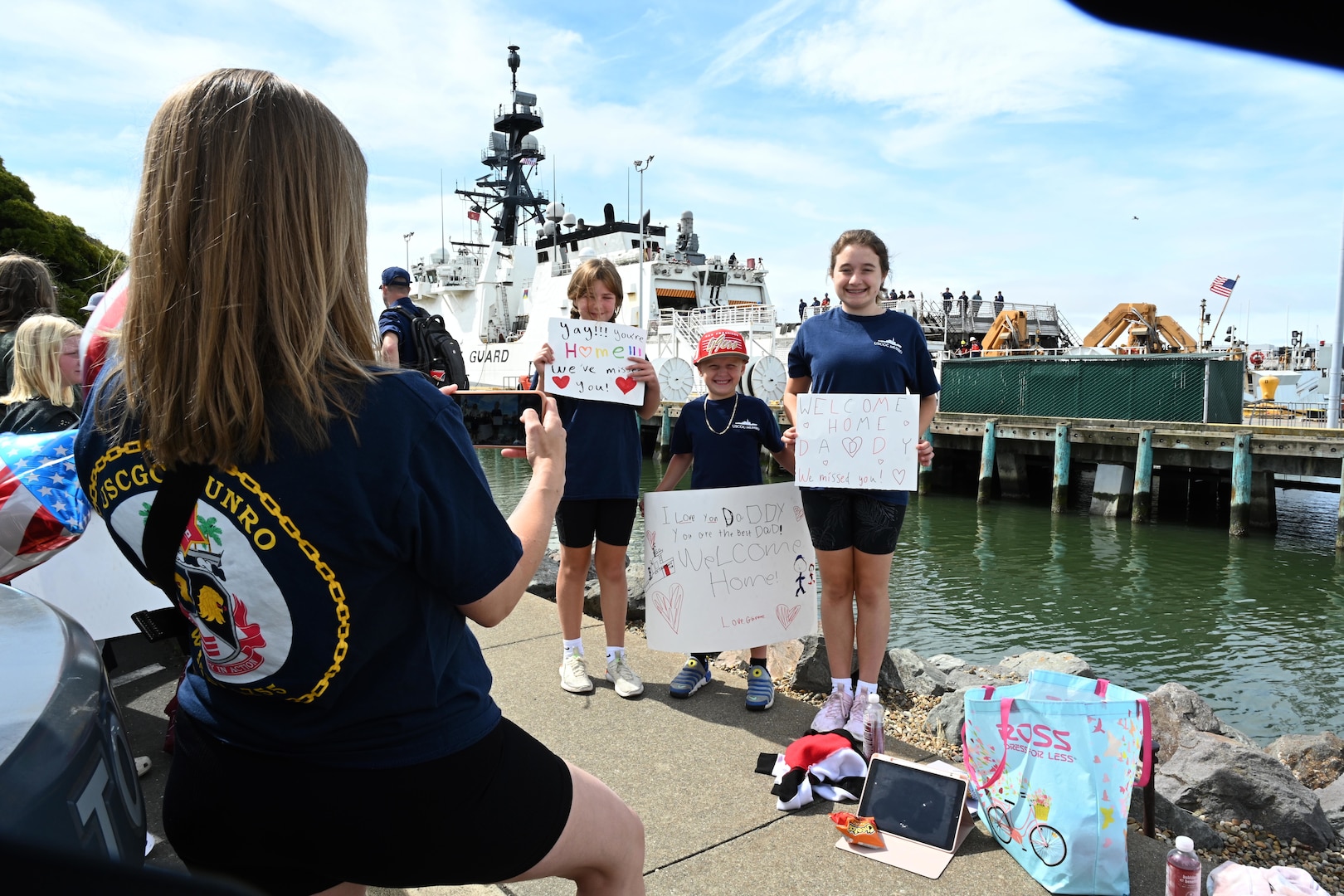 Family and friends await to reunite with loved ones stationed aboard U.S. Coast Guard Cutter Munro (WMSL 755) as the cutter returns home to Base Alameda, California, on June 3, 2024, following a four-month Eastern Pacific patrol. Munro's multi-mission deployment included conducting counter-narcotics missions and Illegal, Unreported, and Unregulated (IUU) fishing patrols. U.S. Coast Guard photo by Chief Petty Officer Matthew Masaschi.