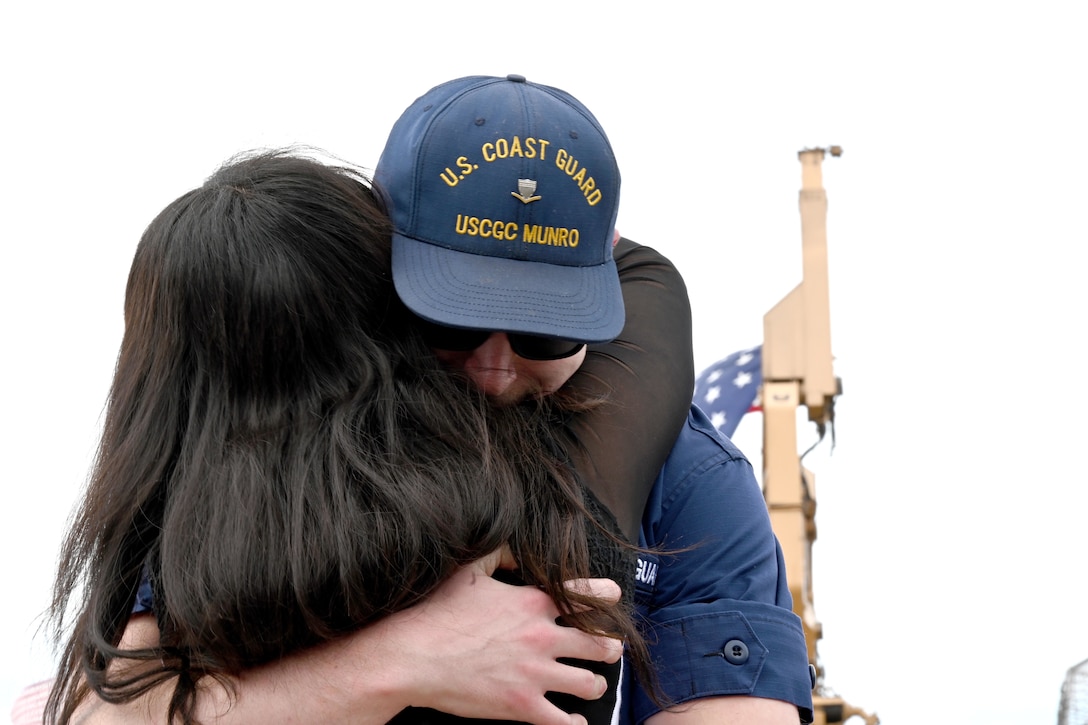 A U.S. Coast Guard Cutter Munro (WMSL 755) crewmember reunites with a significant other after Munro returns to its home port at Base Alameda, California, on June 3, 2024, following a four-month Eastern Pacific patrol. Munro's multi-mission deployment included conducting counter-narcotics missions and Illegal, Unreported, and Unregulated (IUU) fishing patrols. U.S. Coast Guard photo by Chief Petty Officer Matthew Masaschi.