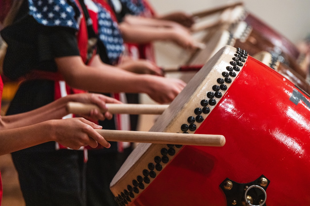Children with Zukeran Elementary School play taiko drums during the 2024 Ages and Stages community event outside the Camp Foster Community Center on Okinawa, Japan, May 18, 2024.  The Marine Corps Community Services New Parent Support branch hosted the event to showcase available parental resources, including parenting classes, briefings, and home visitations. (U.S. Marine Corps photo by Cpl. Jonathan Beauchamp)