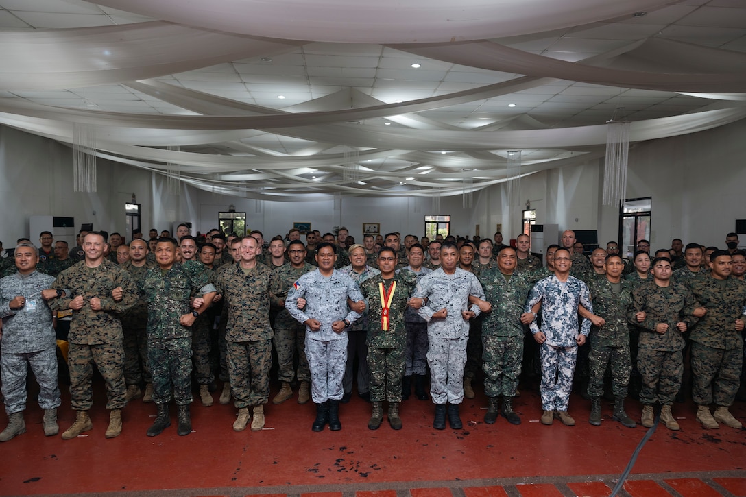 Service members of the Philippine Marine Corps, and U.S. Marines with I Marine Expeditionary Force and 3rd Marine Aircraft Wing, pose for a photo during the Marine Aviation Support Activity 2024 opening ceremony at Fort Bonifacio, Manila, Philippines, June 3, 2024. MASA 24 is an annual Philippine-U.S. military exercise focused on mutual defense, strengthening relationships, and rehearsing emerging aviation concepts. (U.S. Marine Corps photo by Sgt. Shaina Jupiter)
