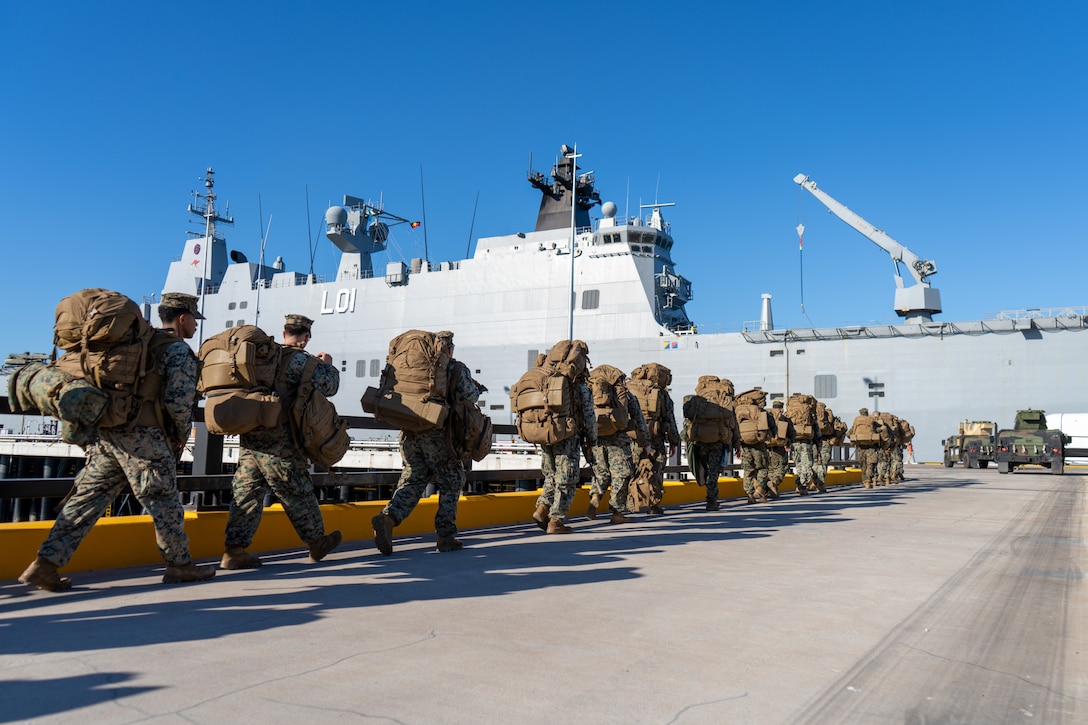 U.S. Marines and Sailors with Marine Rotational Force – Darwin 24.3 prepare to embark on HMAS Adelaide (L01) at Larrakeyah Defence Precinct, Darwin, NT, Australia, June 2, 2024. Marines and Sailors embarked on HMAS Adelaide (L01) alongside their Australian Allies to participate in the Wet and Dry Exercise Rehearsal, transiting from Darwin to Townsville from June 2-20, 2024. During WADER, elements from the MRF-D Marine Air-Ground Task Force will conduct MV-22B Osprey deck landing qualifications, a live-fire deck shoot, medical subject matter expert exchanges, enhance amphibious fires, command and control, and initiate a ship-to-shore movement in order to set conditions for future operational tasking. (U.S. Marine Corps photo by Gunnery Sgt. Kassie McDole)