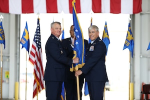U.S. Air Force Maj. Gen. D. Scott Durham, left, 4th Air Force commander, passes the guidon to Col. Douglas Perry Jr., right, incoming 445th Airlift Wing commander, during the wing’s assumption of command ceremony at Wright-Patterson Air Force Base, Ohio, June 1, 2024. Prior to his arrival to the 445th AW, Perry served as the commander of the 434th Operations Group at Grissom Air Reserve Base, Indiana. (U.S. Air Force photo by Senior Airman Angela Jackson)