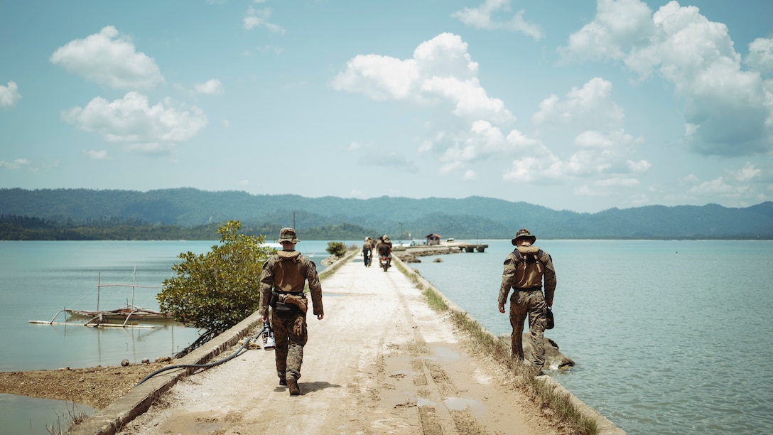 U.S. Marines assigned to the 15th Marine Expeditionary Unit walk down a pier following a maritime domain awareness exchange during Archipelagic Costal Defense Continuum at San Vicente, Palawan, Philippines, May 18, 2024. ACDC is a series of bilateral exchanges and training opportunities between U.S. Marines and Philippine Marines aimed at bolstering the Philippine Marine Corps’ Coastal Defense strategy while supporting modernization efforts of the Armed Forces of the Philippines. (U.S. Marine Corps photo by Gunnery Sgt. Donald Holbert)
