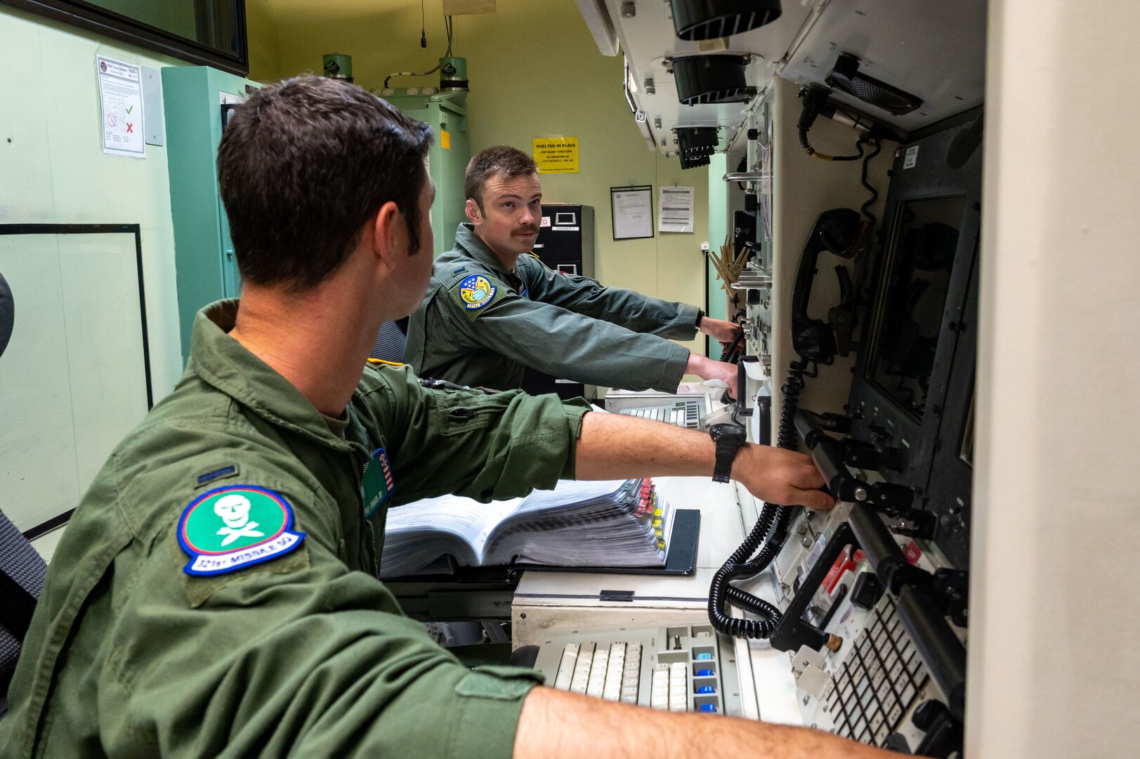 missileers at a missile procedures trainer console