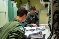missileers at a missile procedures trainer console