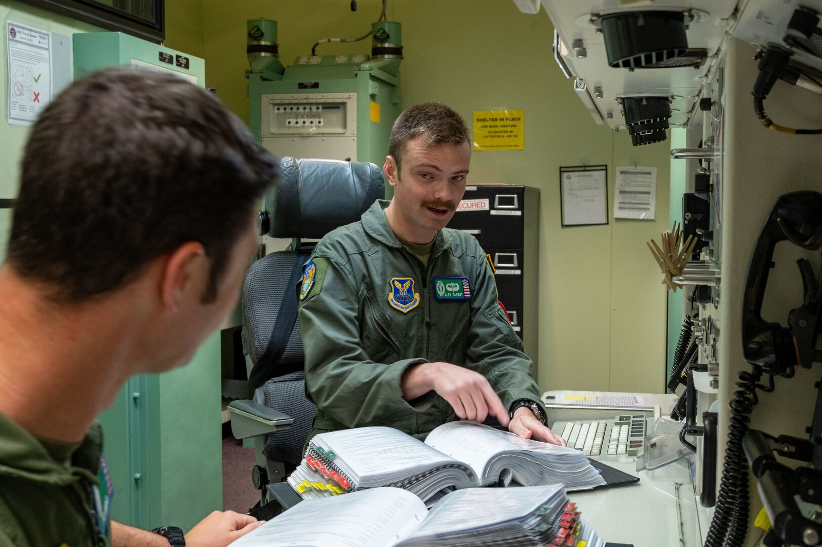 missileers at a missile procedures trainer console