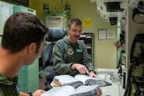 missileers at a missile procedures trainer console