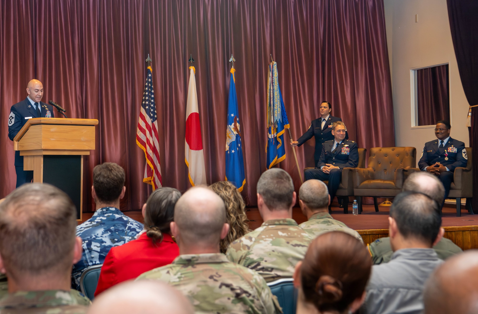 U.S. Air Force Chief Master Sgt. Kenneth Hauck, incoming 374th Airlift Wing command chief, gives remarks.