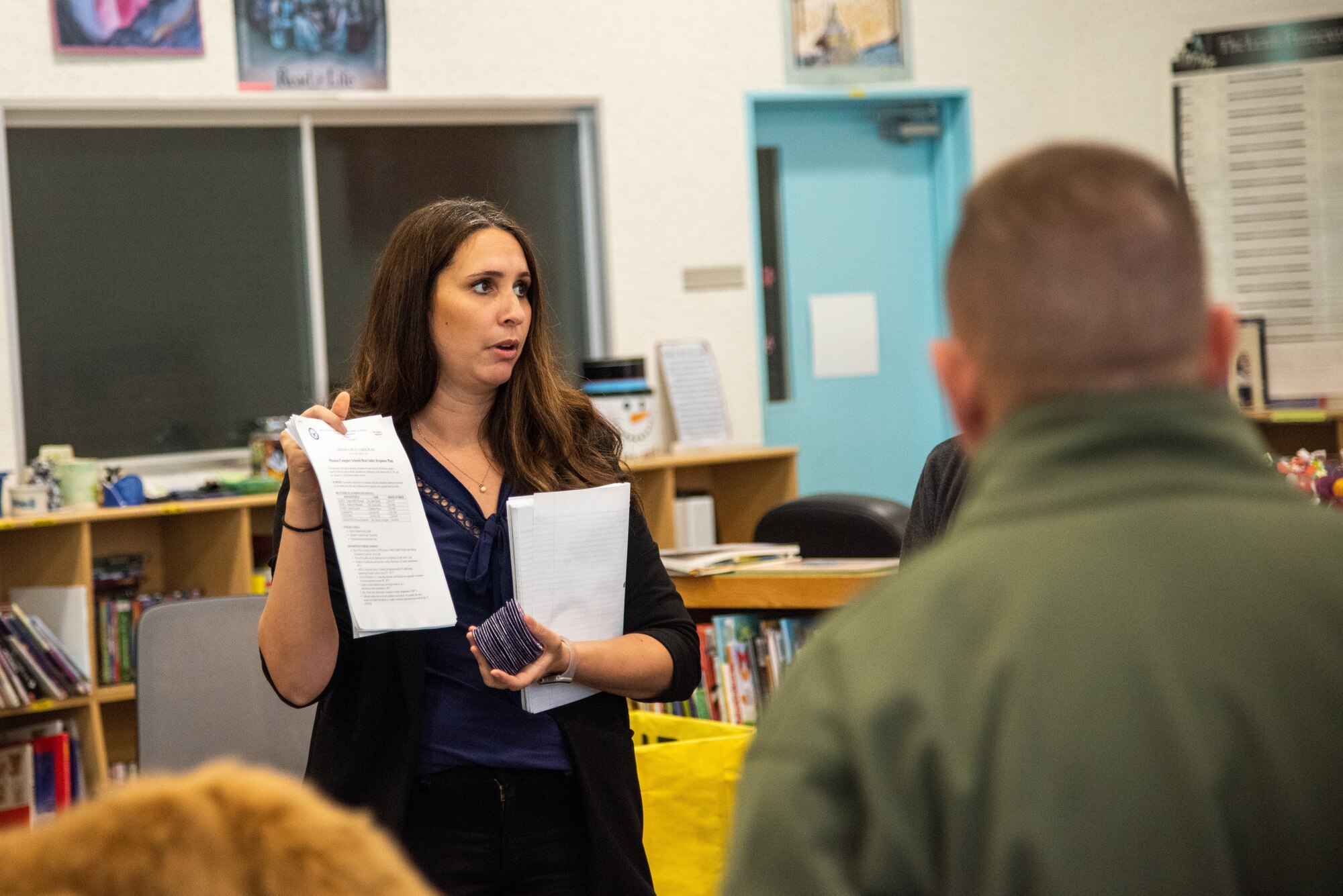 Kandyss Horton, school liaison program manager, explains to U.S. Air Force Lt Gen. Ricky Rupp, U.S. Forces Japan and 5th Air Force commander, and 35th Fighter Wing leadership, school guidelines during a visit to Misawa Air Base, Japan, June 3, 2024.