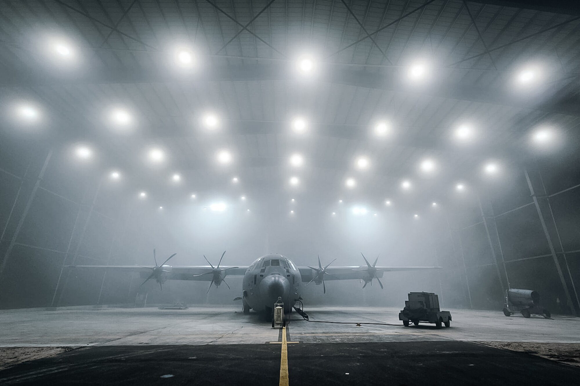 A C-130J Super Hercules sits in a hangar