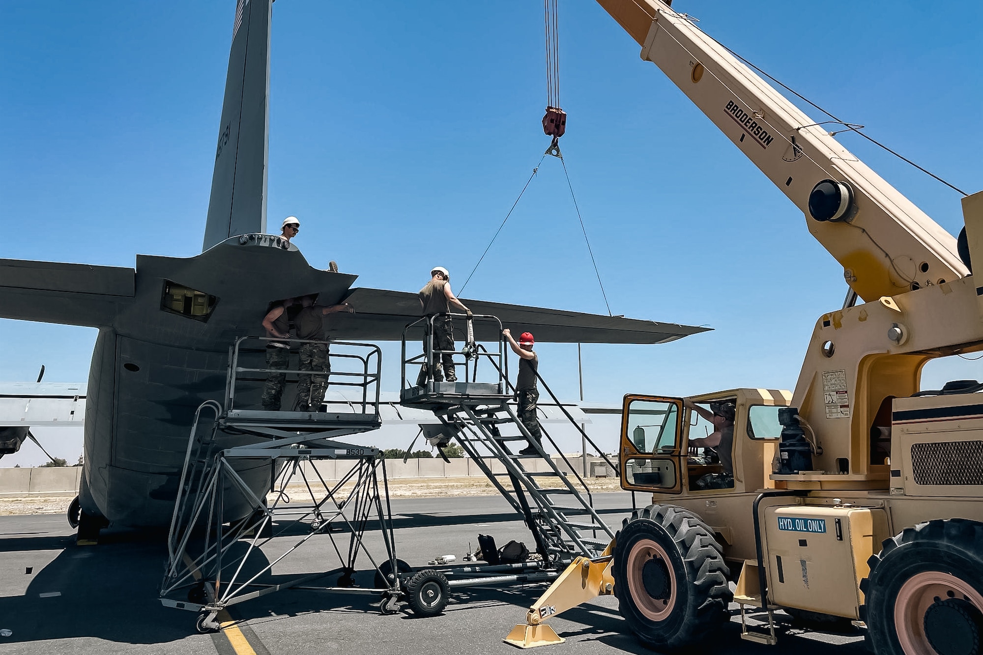Maintenance personnel from the 41st Mission Generation Force Element fix a C-130J Super Hercules wing
