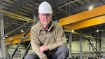 DCMA quality assurance specialist wearing a hard hat in factory in Mannheim, Germany.