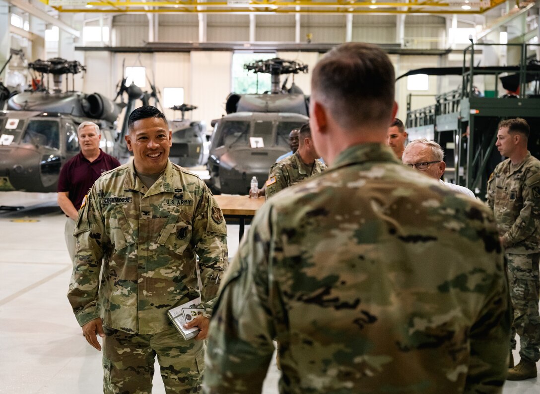 A Soldier smiles at an Airman
