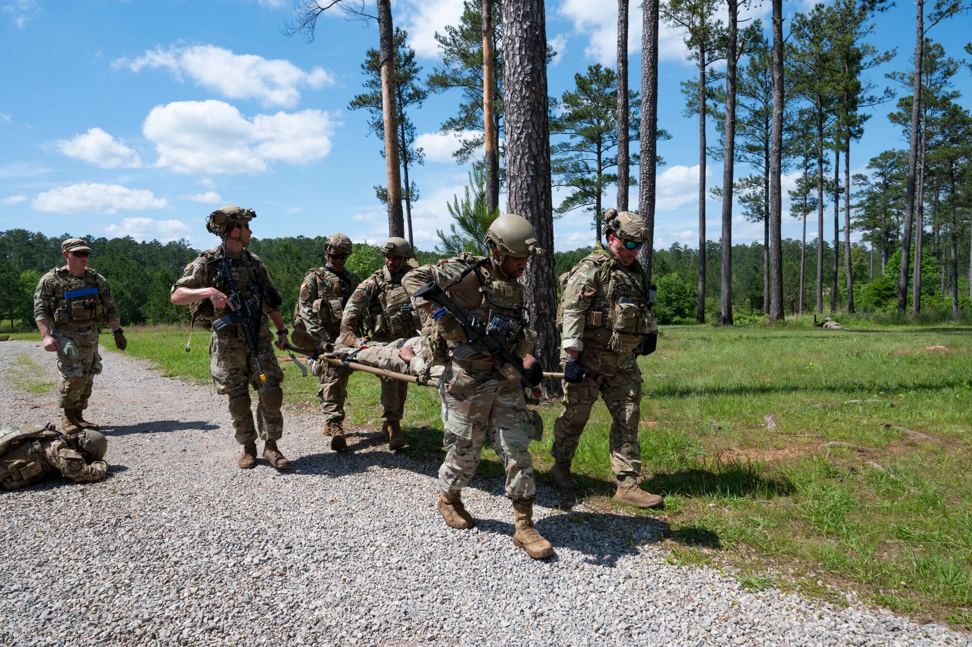 Airmen litter carry a body.