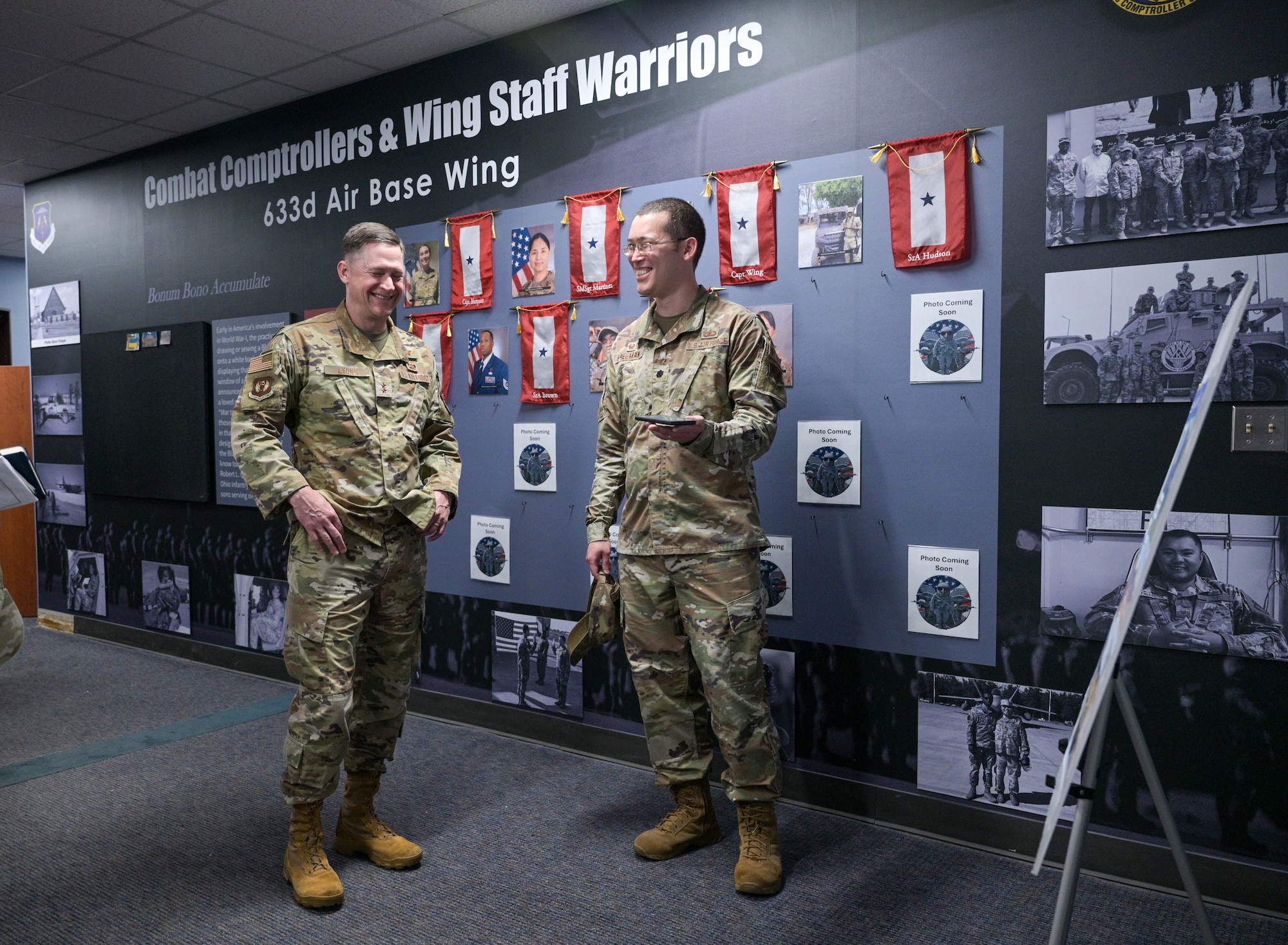 U.S. Air Force Maj. Gen. David Lyons, Fifteenth Air Force commander, left, and Lt. Col. Charlton Freeman, 633d Comptroller Squadron commander, listens to a voicemail, at Joint Base Langley-Eustis, Virginia, June 4, 2024. Freeman played the voicemail from his airman, who was excited to win the ‘Bolt of the Week’ Award, so Lyons could hear the morale the of the 633d CPTS. (U.S. Air Force photo by Airman 1st Class Adisen Smith)